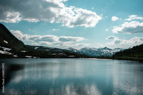 Natural scandinavian beautiful landscape. Glacial lake, fiord, snowy mountains. Sunny day in nortnern Norway.  © Joanna
