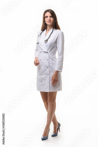 Model in medical clothing with stethoscope poses on a white background
