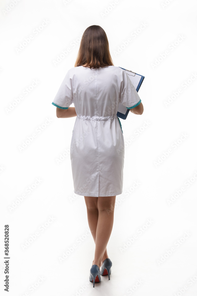 A girl in medical clothing stands back nwa back background A girl in medical clothing stands back nwa back background