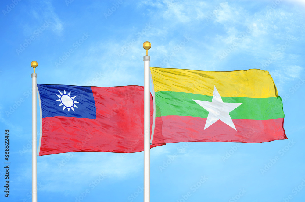 Taiwan and Myanmar two flags on flagpoles and blue sky Taiwan and Myanmar two flags on flagpoles and blue sky