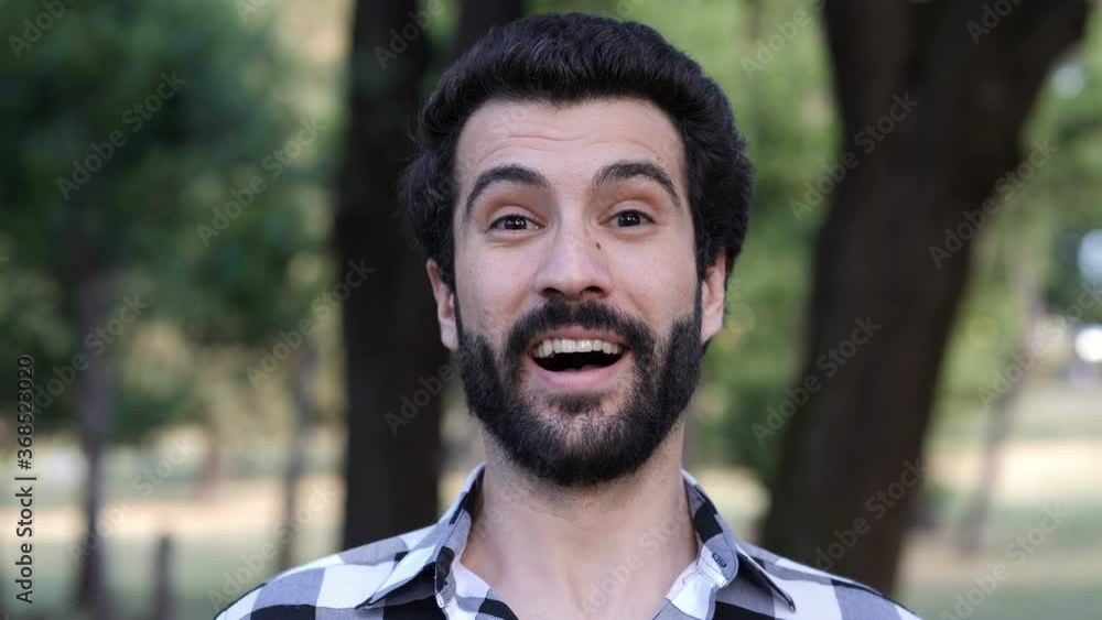young serious man suddenly bursts out laughing in front of the camera young serious man suddenly bursts out laughing in front of the camera