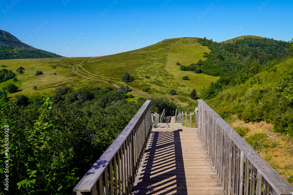 wooden bridge access to the Puy de Dôme volcano from Puy Pariou in Auvergne french