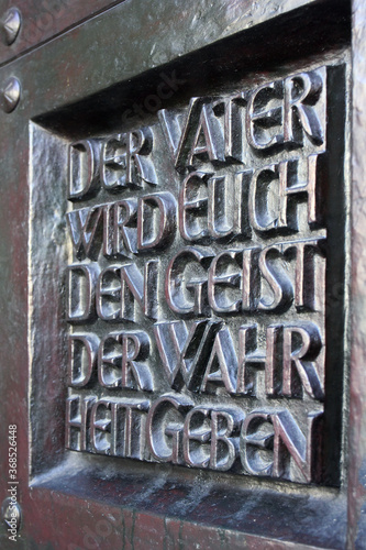 Bronze church door with quotation from the Bible (Translation of German: the father will give you the spirit of the truth.)