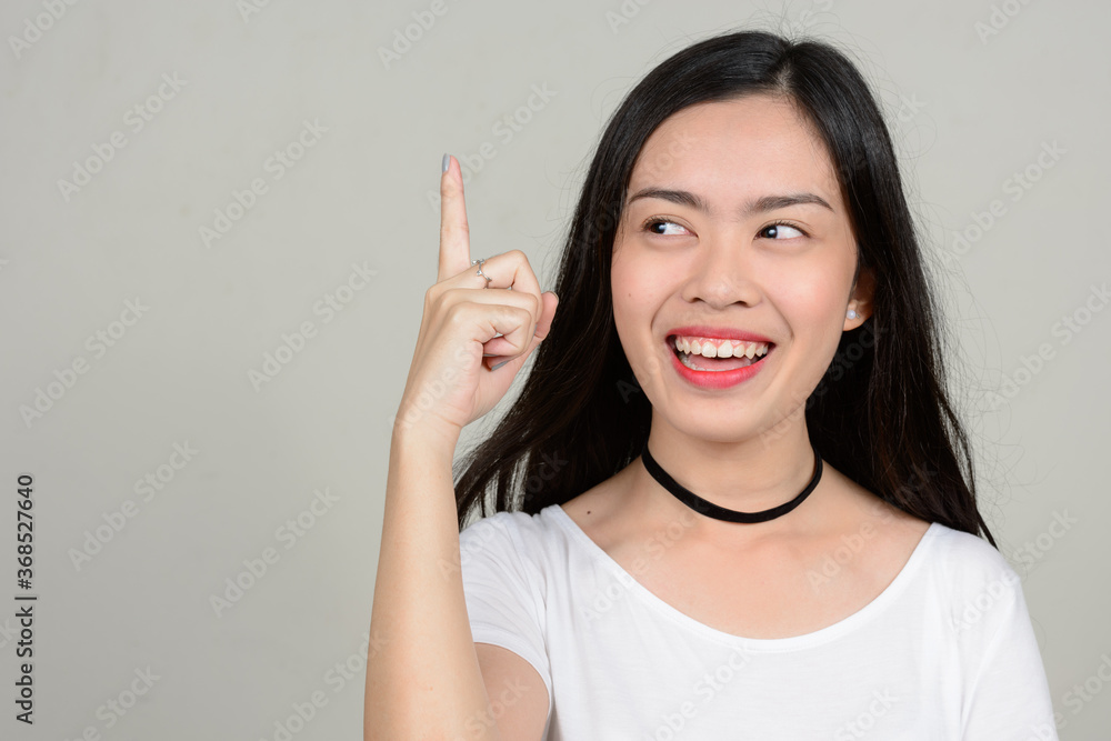 Portrait of happy young beautiful Asian woman Portrait of happy young beautiful Asian woman
