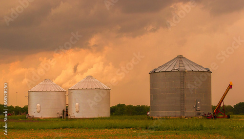 Rural farm under orange skies.