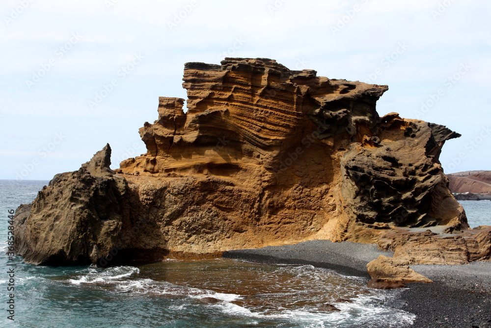 Colourful orange rock in the sea near El Golfo Lanzarote, Canary Islands