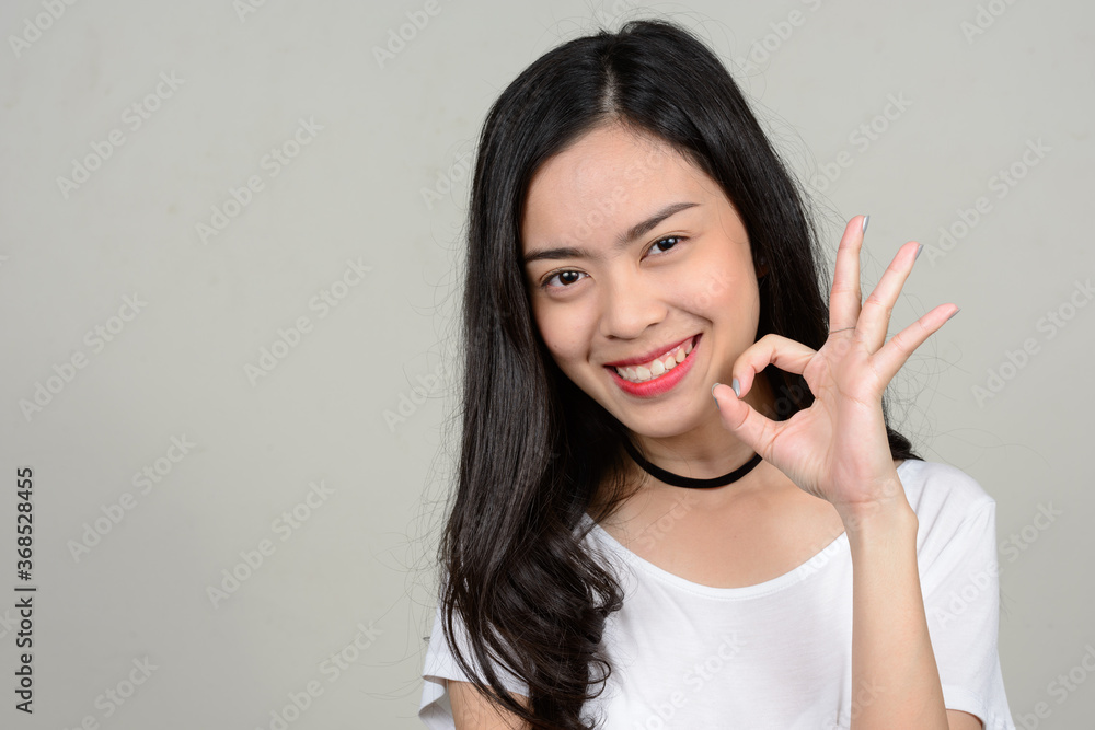 Portrait of happy young beautiful Asian woman Portrait of happy young beautiful Asian woman