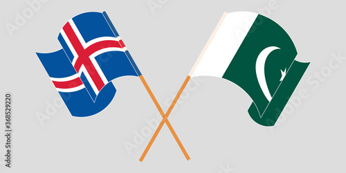 Crossed and waving flags of Pakistan and Iceland