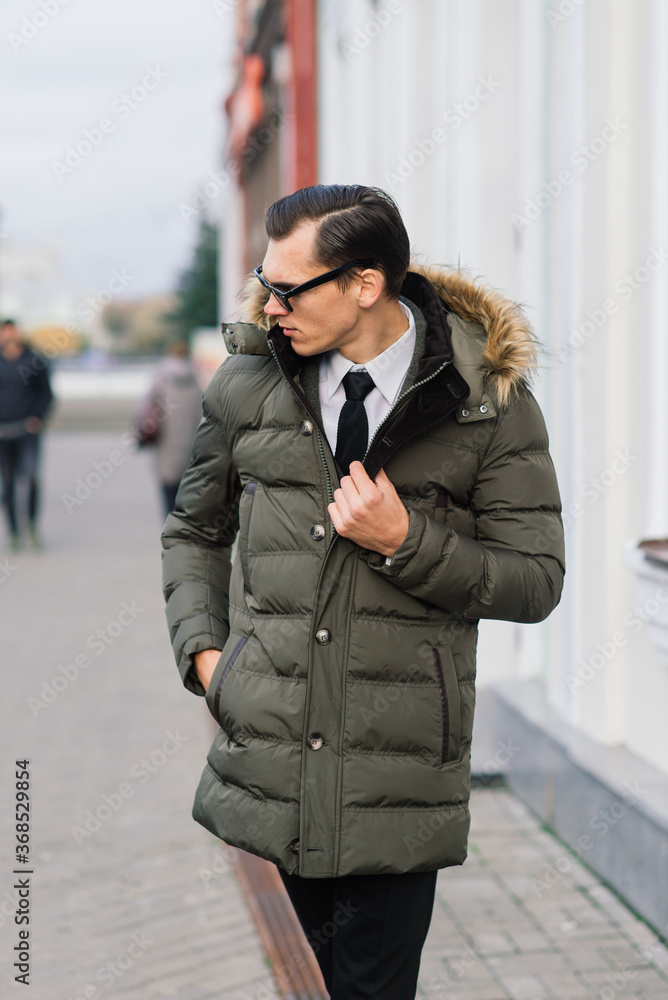 Man in a stylish suit. Businessman in an autumn city, fashion Man in a stylish suit. Businessman in an autumn city, fashion