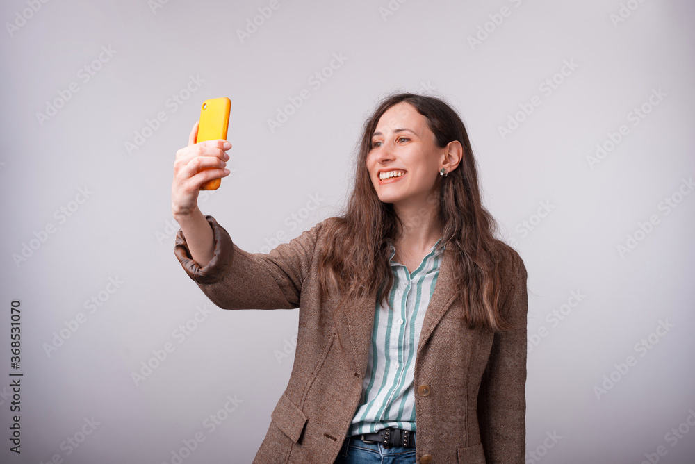 Portrait of charming young business woman taking selfie with smartphone. Portrait of charming young business woman taking selfie with smartphone.