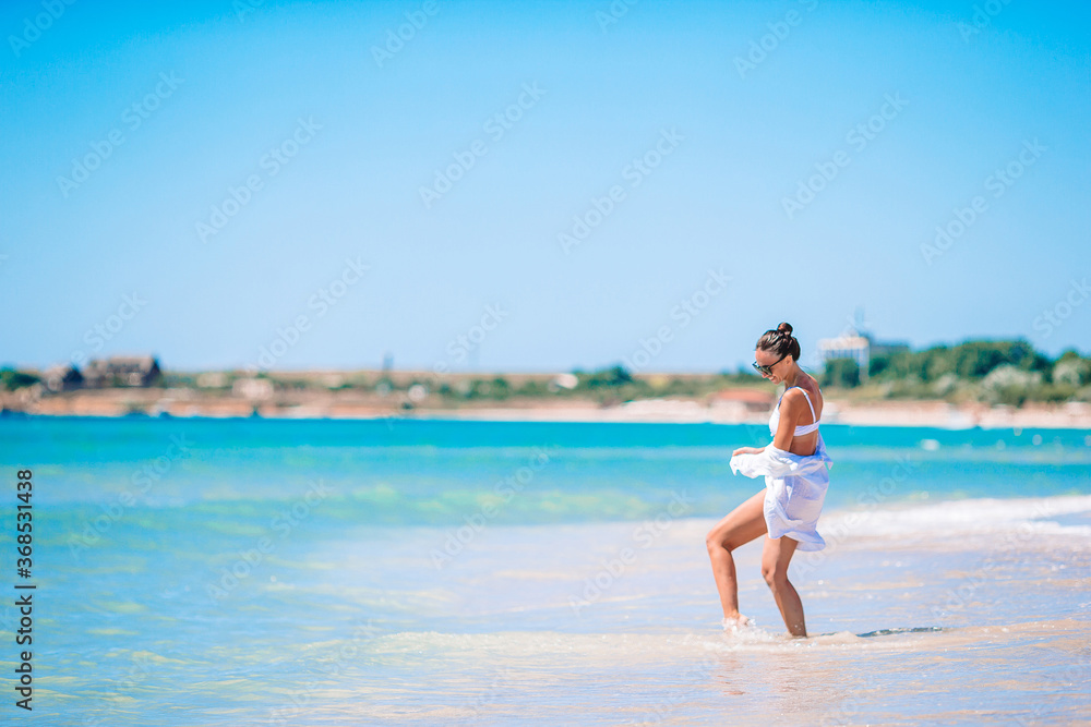 Young woman in white on the beach