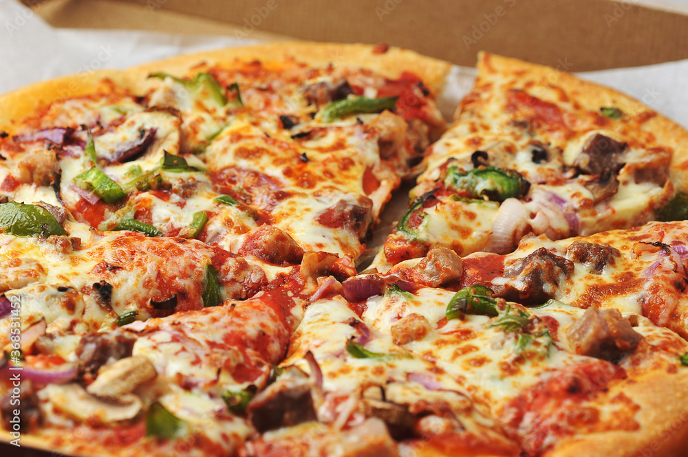 Meat pepper pizza lies on cardboard packaging Meat pepper pizza lies on cardboard packaging
