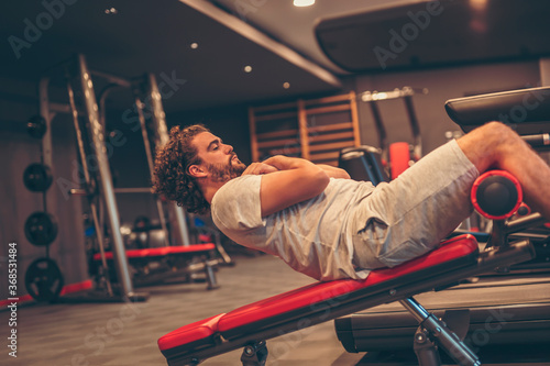 Man doing incline bench sit ups
