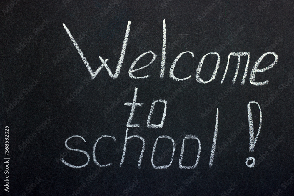 Lettering on the chalk board welcome to school. Greeting students
Lettering on the chalk board welcome to school. Greeting students
