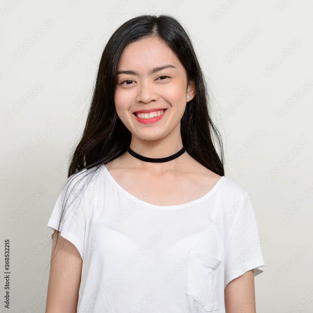 Portrait of happy young beautiful Asian woman Portrait of happy young beautiful Asian woman