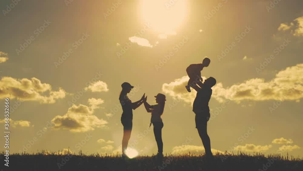 Happy family walking in field on sunny day. Concept of friendly family. Happy family walking in field on sunny day. Concept of friendly family.