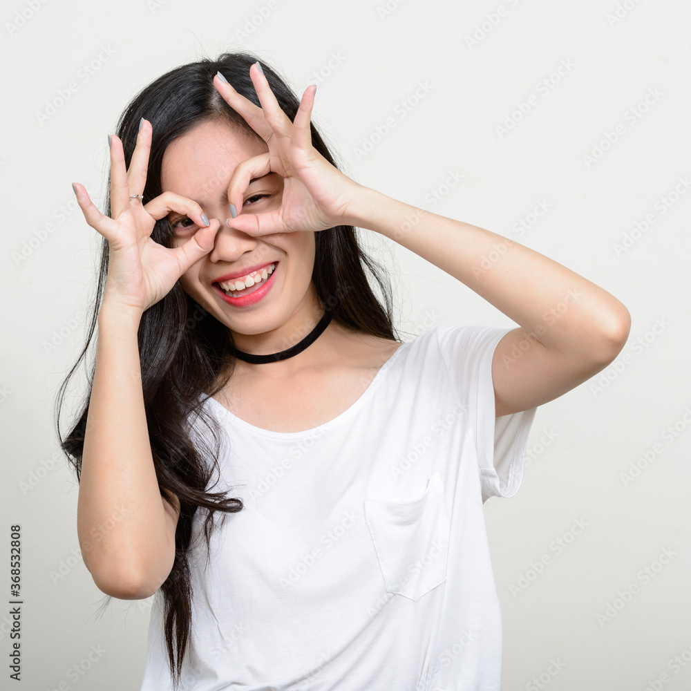 Portrait of happy young beautiful Asian woman Portrait of happy young beautiful Asian woman