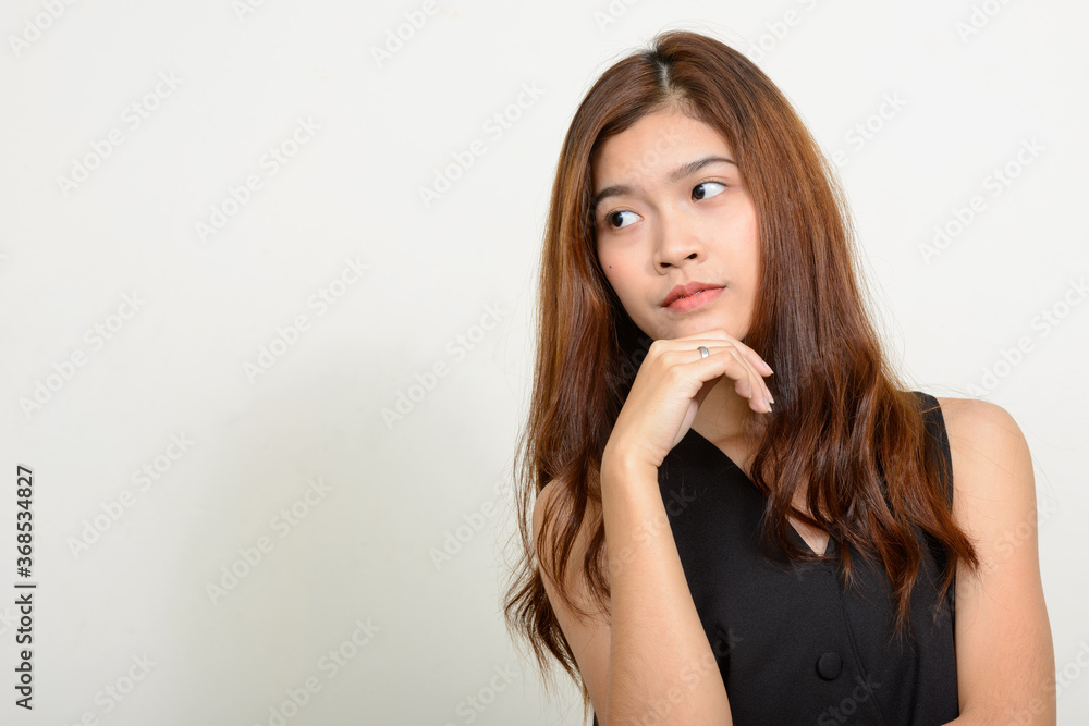 Portrait of young beautiful Asian woman against white background Portrait of young beautiful Asian woman against white background