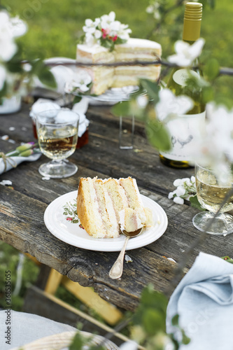 Rustic wedding cake with white lilac, light background, close up, selective focus