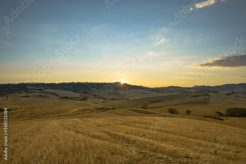 First rays of summer sunrise over Pienza, Val d'Orcia, Tuscany, Italy