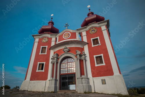 Panorama of top part or the end of Banska Stiavnica Cavalry in central Slovakia during afternoon hours. Picturesque baroque building in red and white rising up.
