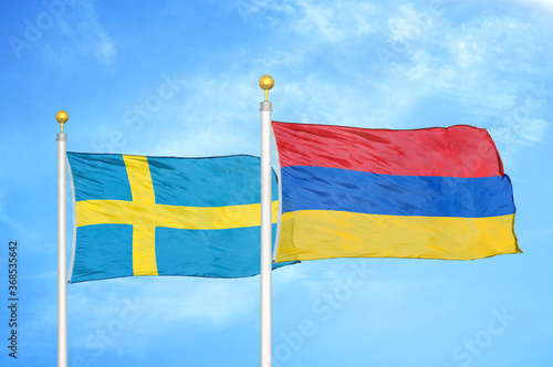 Sweden and Armenia two flags on flagpoles and blue sky