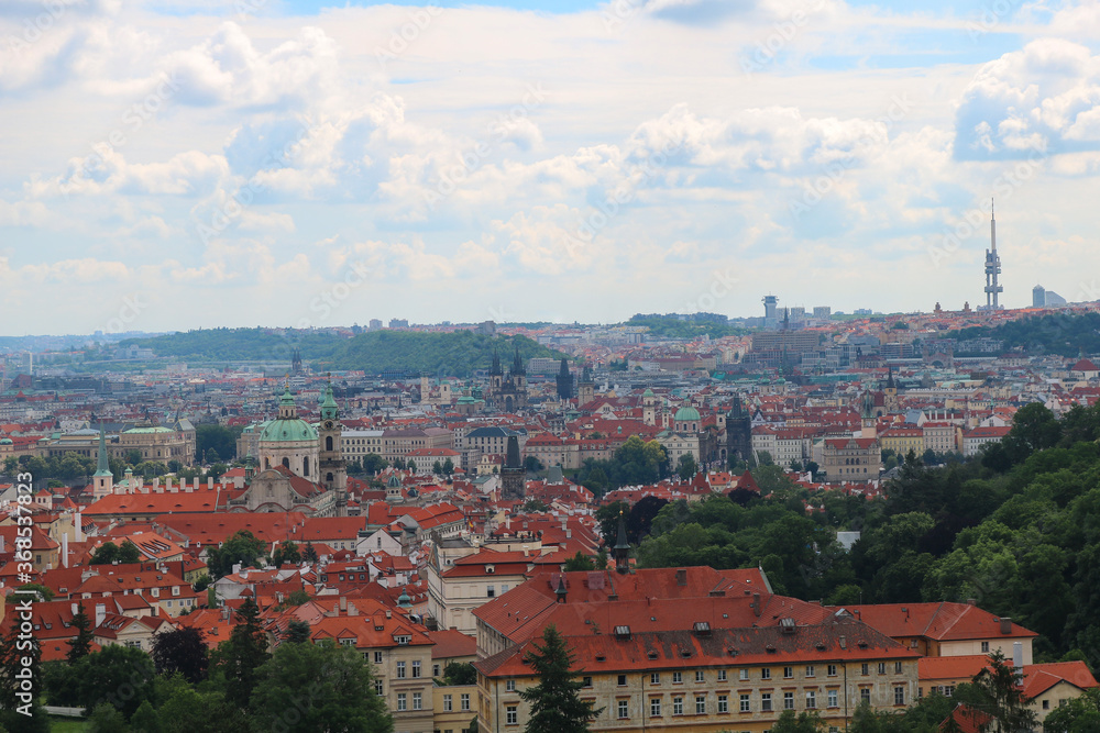 Panorama of the historical center of Prague from the Charles bridge to the Zizkov TV tower on a Sunny summer day under the clouds.