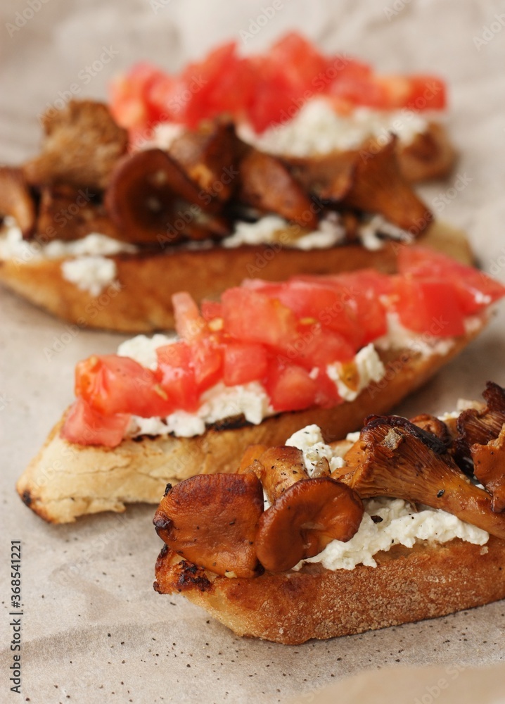 Bruschetta with red tomatoes and chanterelles macro Bruschetta with red tomatoes and chanterelles macro