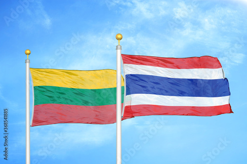 Lithuania and Thailand two flags on flagpoles and blue sky