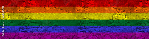 seamless panorama of LGBT rainbow flag on an old stone wall with cracks, the concept of historical, tourism, emigration, economy, politics, global world trade © kittyfly