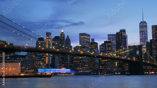 landscape of lower manhattan with Brooklyn bridge  east river at night time © mimilee