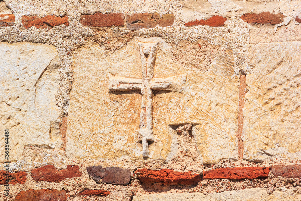 View of a part of the wall of an ancient Byzantine Christian temple with a cross closeup, the Black Sea coast of Bulgaria