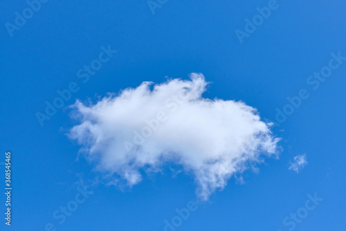 White solitary cloud in blue cloud close up.
