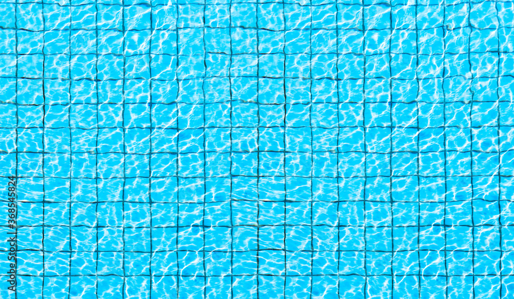 Top view of swimming pool bottom caustics ripple and flow with waves background. Summer background. Texture of water surface. Top view of swimming pool bottom caustics ripple and flow with waves background. Summer background. Texture of water surface.