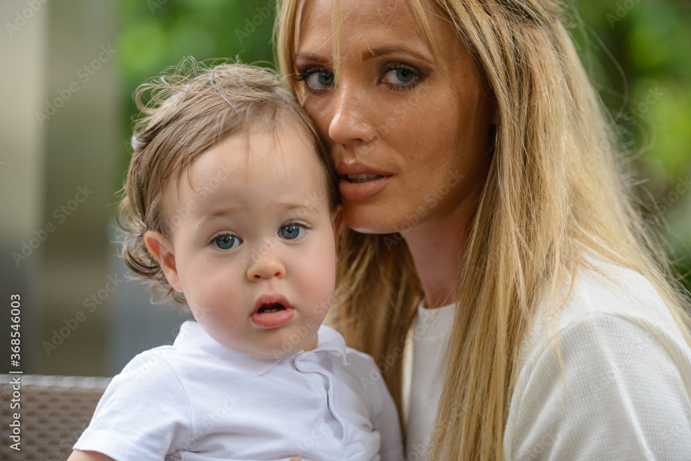 Young beautiful blonde mother with adorable baby son together Young beautiful blonde mother with adorable baby son together