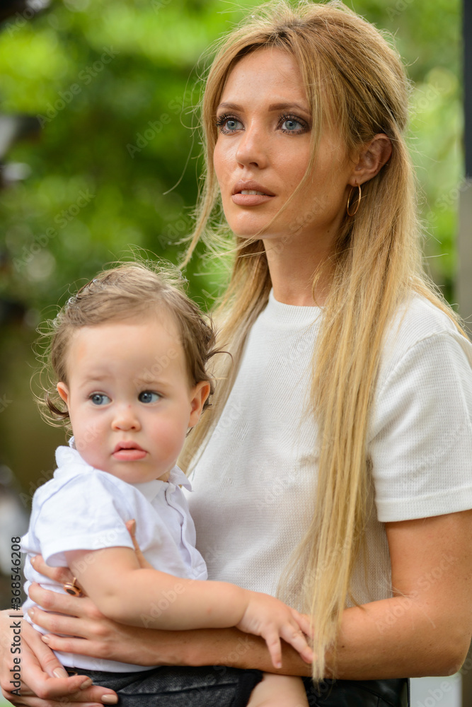Young beautiful blonde mother with adorable baby son together Young beautiful blonde mother with adorable baby son together