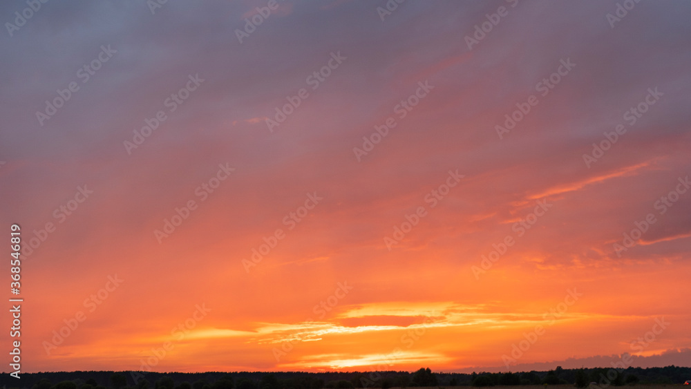 Red sunset sky with multicolor clouds. Heaven concept. Space for text.