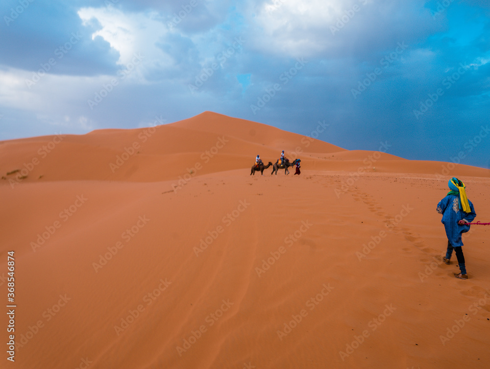 man walking in the sand dunes
