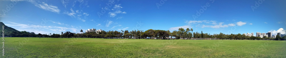 Kapiolani Park at during day with Diamond Head and clouds Kapiolani Park at during day with Diamond Head and clouds