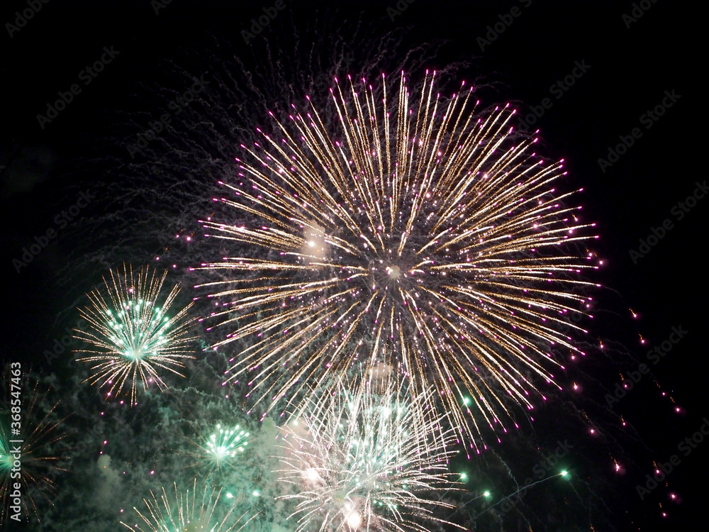 Friday Night Waikiki Fireworks with white and green color burst in the air Friday Night Waikiki Fireworks with white and green color burst in the air