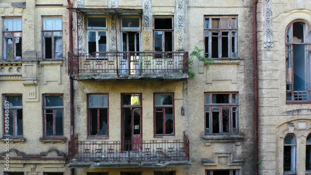Abandoned old apartment building in the Art Nouveau style (Modern Style) with a broken windows. Deserted early 20th century house. Aerial side view Abandoned old apartment building in the Art Nouveau style (Modern Style) with a broken windows. Deserted early 20th century house. Aerial side view