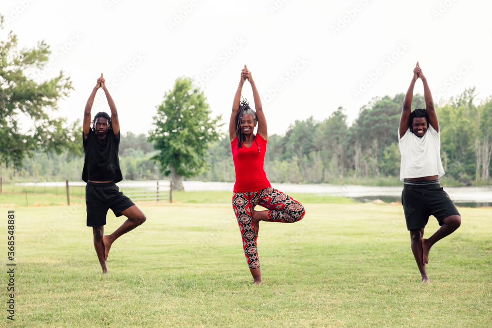 © Creative Flame - Mother and sons doing yoga in park © Creative Flame - Mother and sons doing yoga in park