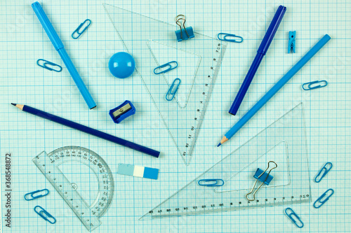 monochrome background with set of blue stationery. school learning and education concept.