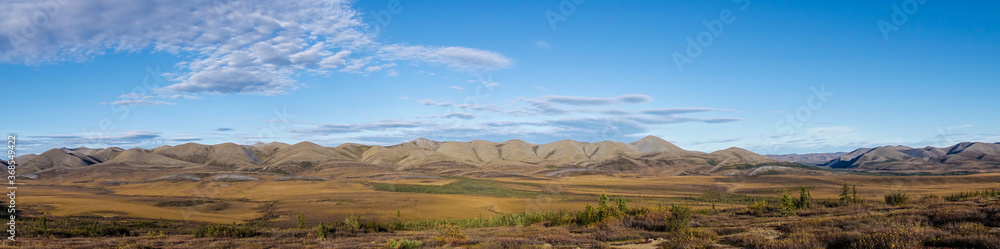 Arctic Tundra in fall with mountains and clouds in the Yukon Panaorama 