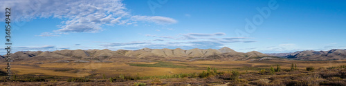 Arctic Tundra in fall with mountains and clouds in the Yukon Panaorama 