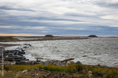 Arctic Ocean from Tuktoyaktuk with Pingo in the distance 