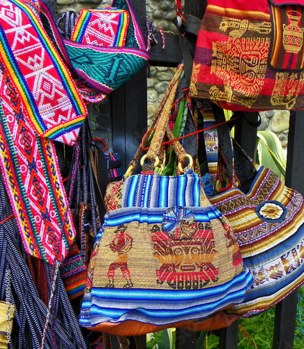 Colorful souvenirs bags and belts made of textiles with a traditional ornaments of Peru