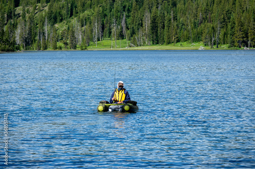 Man fishing on a lake at Yellowstone National Park, Wyoming, USA