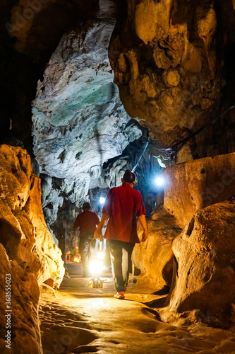 Chiang Mai, Thailand - August 1, 2020: Chiang Dao cave, tourists walk along the bridge in the stone corridor