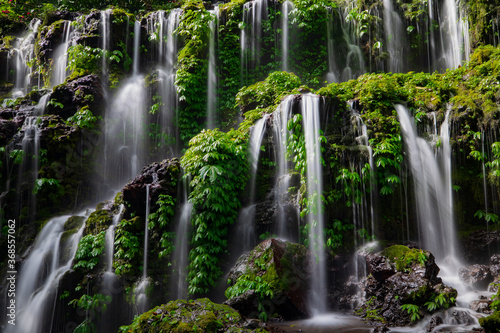 Close up of waterfall. Dynamic water flow. Waterscape background. Nature and environment concept. Banyu Wana Amertha waterfall Bali, Indonesia photo